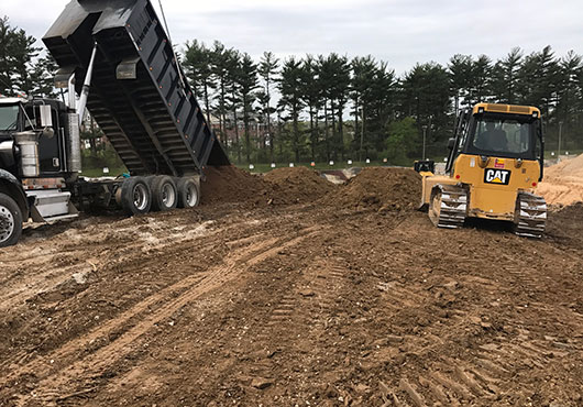 As part of a retrofit of an existing sediment pond at an aggregate supplier’s yard in Hanover, Maryland, Cedar Lane Excavation is replacing the clay layer on the pond bottom.