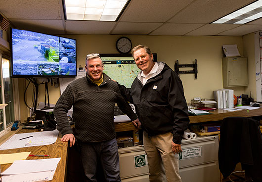 Dave Ross, right, checks on schedules with Bob O’Brien, operation team member, who maintains the support systems that are so critical to staying on track with client needs.