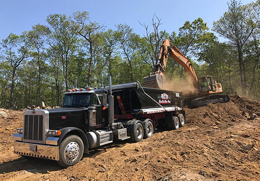 Crew members unloaded and screened approximately 1,500 yards of loam to use on-site for a new storage facility. ATL Construction, Inc. provided all of the site work and blasting for the project.