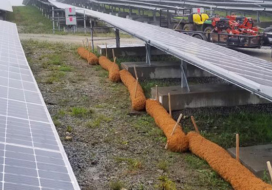 At this solar farm, laborers installed coir logs, densely packed mattress coir fibers inside a tubular coir twine netting, for maximum soil reinforcement.