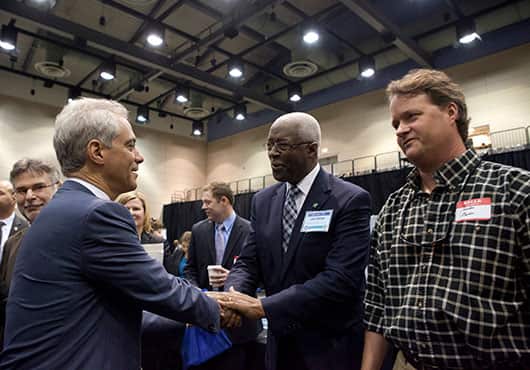 Chicago Mayor Rahm Emanuel (left) welcomes Larry Bullock (middle) to the city of Chicago’s Vendor Fair in 2014.