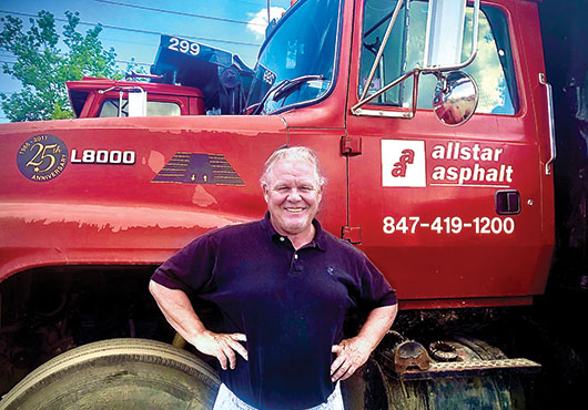 CEO Steve Gagnon stands in front of the Allstar Asphalt, Inc. fleet of trucks.