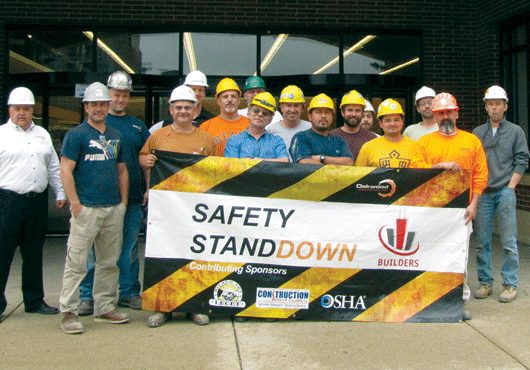 Howard Turner holding “Turner on Illinois Mechanics Liens,Oakwood Contractors employees pose proudly with a Safety Stand-Down banner in front of a Jewel-Osco supermarket.” the book he authored that is now considered the authoritative work on Illinois mechanics lien law. 
