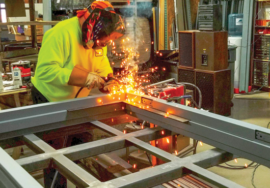 Welder Art Sargent fabricates a hollow metal frame for a customer’s door installation.