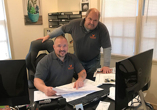 Heritage Fence Company President Christopher Caruso (seated) and Residential Sales Manager Todd Clayton are just part of the company’s estimating team.