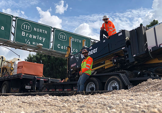 Cal Empire Engineering Inc.’s Mark Gariffo, HDD Operator and Anthony Ciancio, HDD Locator, one of six directional bore crews, prepare to construct underground utilities along a major California highway. 