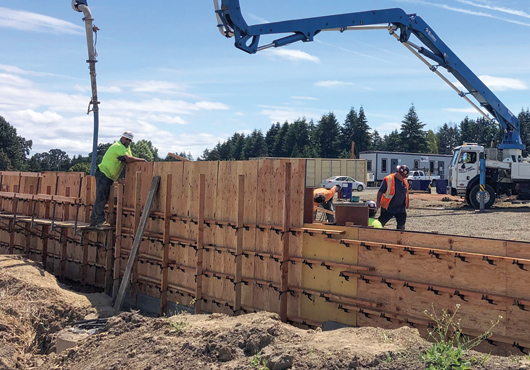 Crews pour the footing stem wall for the foundation of Global Electric, Inc.’s new headquarters.