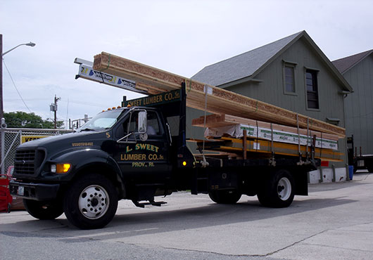 L. Sweet Lumber Company, Inc. employees prepare to deliver a framing load containing engineered lumber for a new home.