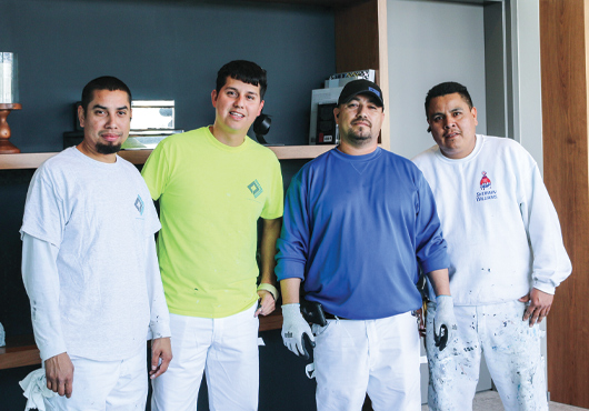 A General Coatings Corp. painting crew takes a break from working on a commercial job site. Pictured (from left): Painters Jermey Gonzales and Elmer Castillo, Foreman Joe Reyna, and Painter Marco Calvillo.