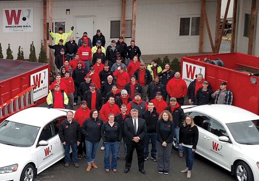 Wrecking Ball Construction office staff and part of the field crew gather at team headquarters in Everett, Wash.