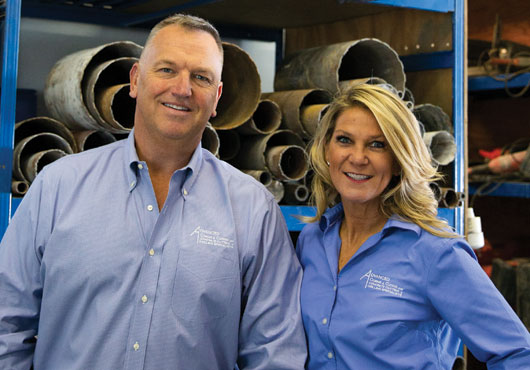 Steven Lisowski, President of Advanced Coring & Cutting Corp., with his wife, Kristin, who helps oversee internal operations, in the company’s workshop.