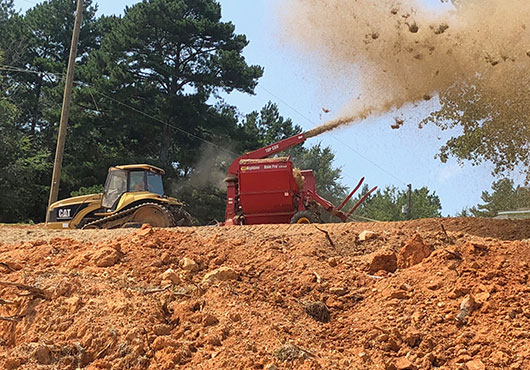 BC Landscaping Inc. is headquartered in Gainesville, Georgia. Here, the company puts down mulch on a Georgia Department of Transportation project to prevent erosion.