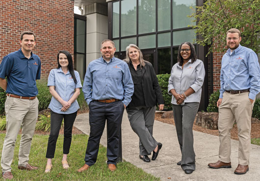 Members of the company’s preconstruction team take a break outside of WEAVERCOOKE headquarters (left to right): John Hoots, Caroline Pate, Chris Lee, Laura Yountz, Valarie De Pass and Brit Cohan.