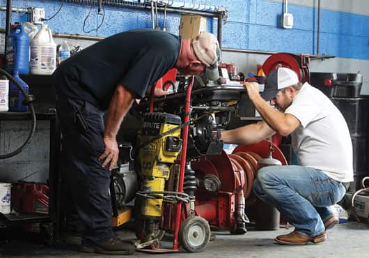 Jason Tate (right) and Shop Manager Mike Ayers going over equipment repairs.