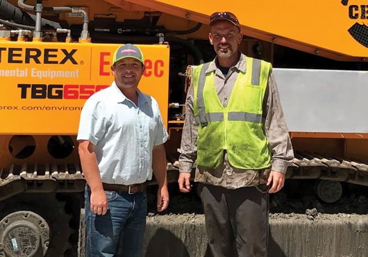 Ronnie Petty, President, and Eddie Lathem, grinding crew leader, in front of a CBI 5800 series horizontal grinder from Powerscreen Mid-Atlantic in Kernersville, North Carolina.