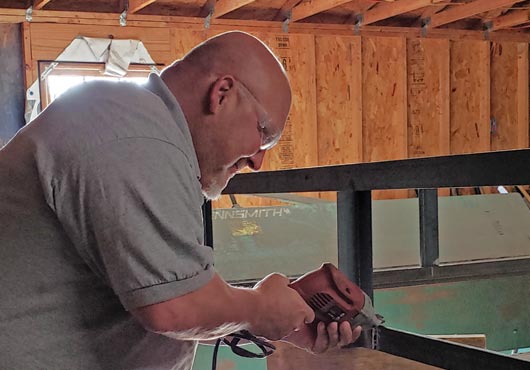 Shown working on trailer frames at his company’s warehouse in Elm City, NC, is Scott Bailey, Owner and President of Statewide Sheetmetal and Roofing.
