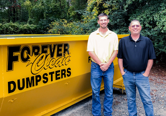 Father and son team, Scott and Nick Tart, in front of a Forever Clean dumpster.