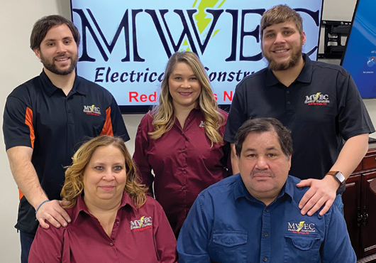 Two generations of M-W Electric, Inc.: Owners Kimberly and Mike Woods (front) and Project Managers and Estimators (back row from left) Cameron Woods, Miranda Woods Chavis and Kyle Woods.