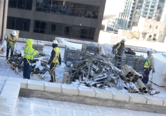 Crew members on the snowy rooftop of the historic Equitable Building in downtown Denver.