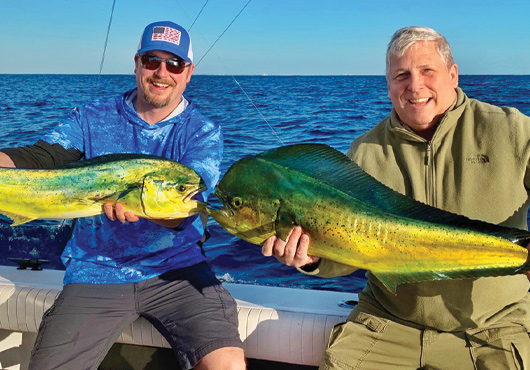 Father-son team Pete Capistrant (right), President, and Brent Capistrant, Vice President, enjoy fishing for mahi mahi together and sharing management duties for Allied Blacktop CO. 