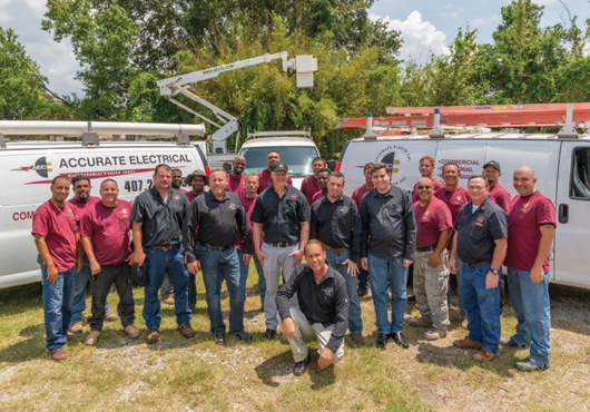 President Stan Courtney Jr., kneeling, with the Accurate Electrical Connection, Inc. field and management teams in Orlando, Florida.