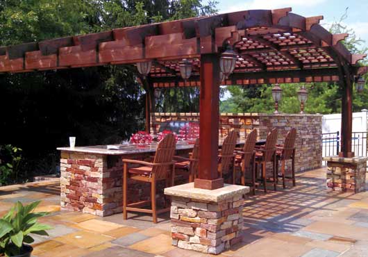 An outdoor living space built by McCarrell Landscape Construction, LLC, complete with a pergola.