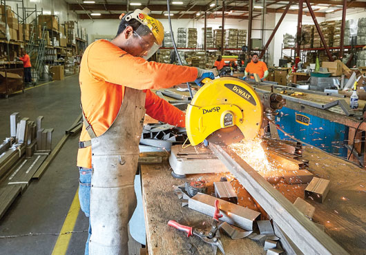 Downspout and gutter being cut to length in the shop and readied for the job site. 