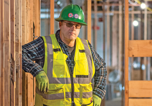 Curtis Bond, Founder and President of Bond Plumbing LLC, inspects the restroom plumbing work for the new Park Ridge Activity Center, Bothell, WA.