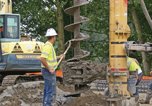 Employees drill 70-foot auger cast piles for a dry storage warehouse for Commercial Cold Storage in Mount Vernon, WA.