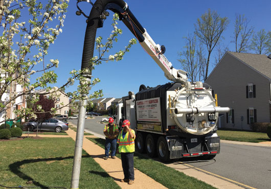 Capital City Services owner and President Wayne Norman supervises the hydro excavation of site in support of the repair of a broken water line. 