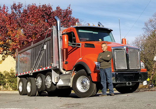 Rick George, owner of Paveco Asphalt Paving and Sealcoating, with his company’s new Kenworth quad-axel dump truck. Paving has long been a family business, started by Rick’s dad and two uncles back in 1958.