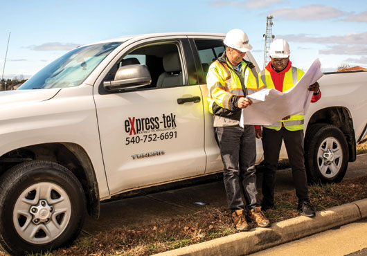 Express Technologies, Inc.’s OSP/Relocation team members (left) Keith Ward, OSP Manager, and Thomas Aluoch, Engineer, design and build fiber optic cables in the field.